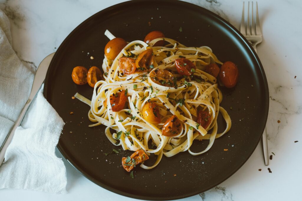 Savor a classic Italian pasta dish featuring linguine with roasted cherry tomatoes, perfect for a healthy meal.